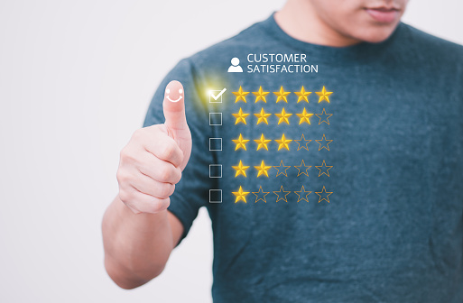 Satisfaction survey and customer service concept, businessman using a smartphone to answer the questionnaire and give a satisfaction rating, offering a 5-star satisfaction rating