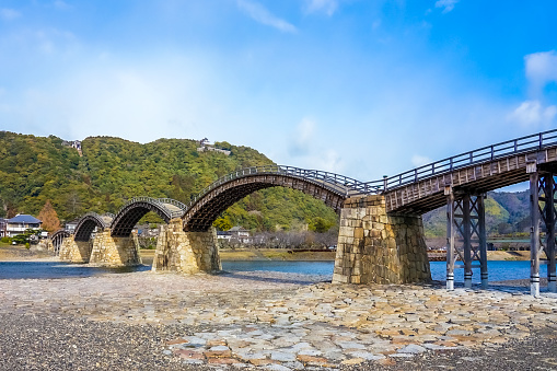 Kintaikyo Bridge with blue sky along the Nishiki River in Iwakuni, Yamaguchi Prefecture on a sunny spring morning in March 2023