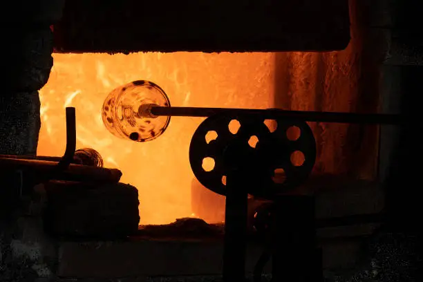 A glass bottle heated in a glass melting furnace, so it can be manipulated.
