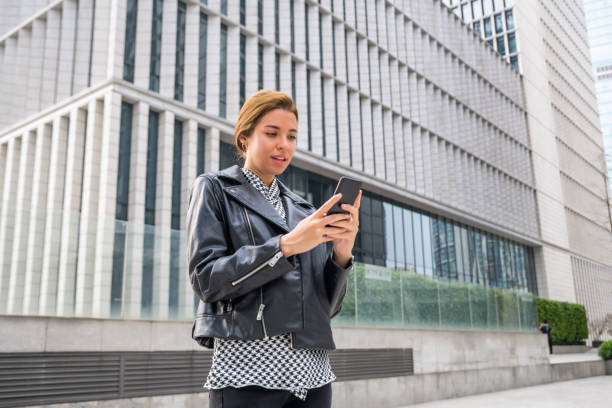 istock Female visitor reading travel info on her smartphone 1476119202