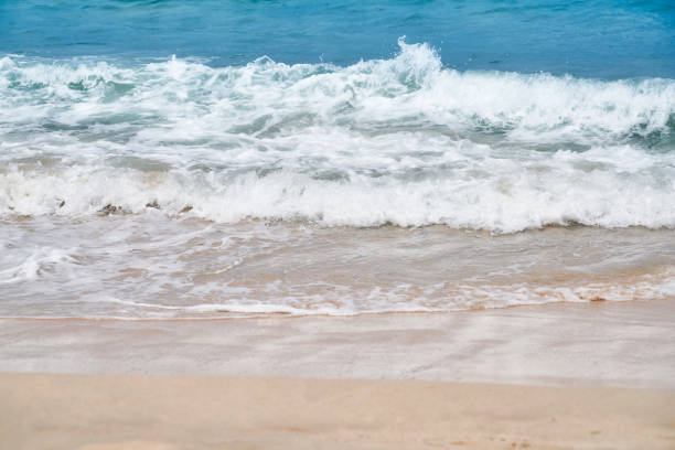 istock Seascape with splashing wave on clean sand beach 1476120673