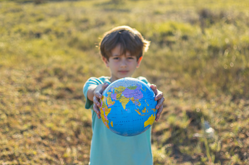 Boy Showing The Globe Earth. Concept Of Saving The Planet