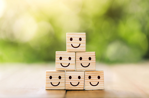 Wooden cube block shape with icon face smiley, The best excellent business services rating customer experience,Satisfaction survey concept. Customer service evaluation and satisfaction survey concepts