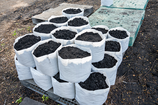 Prepare the soil for planting in a white bag. Prepare the Organic Soil bare soil garden. humus fertilizers, leaf fertilizers