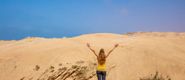 istock Woman in dune in the desert- Morocco 1476123728
