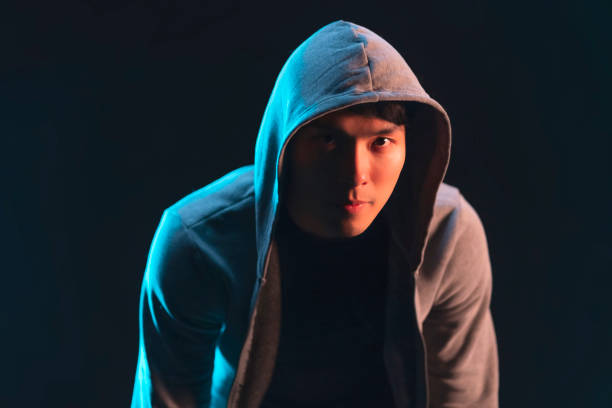 istock asian sport man male with jacket hood ready to workout concentrate focus action pose studio shot on dark background,action sport fashion stylish studio shot closeup half body 1476130906
