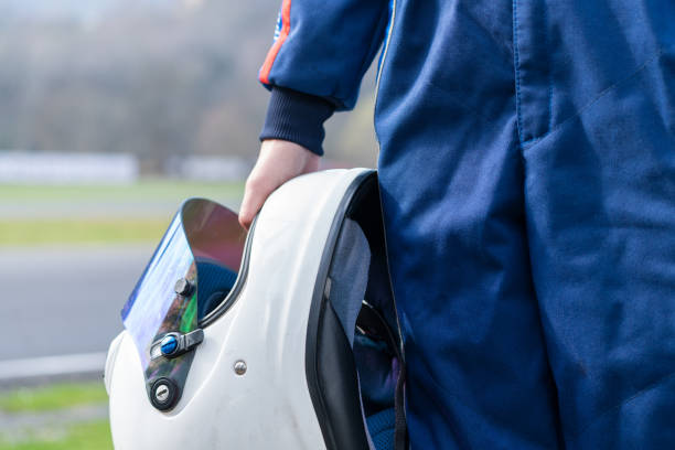 istock Racer helmet in hand close-up. 1476131932