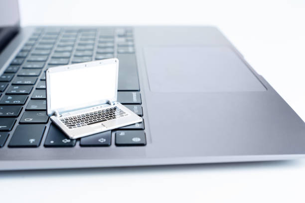 istock Miniature Laptop Replica on Full-Size Laptop Keyboard 1476132606