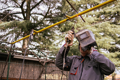 Senior man who likes to be creative in his retirement, decided to gather scrap metal and create something useful