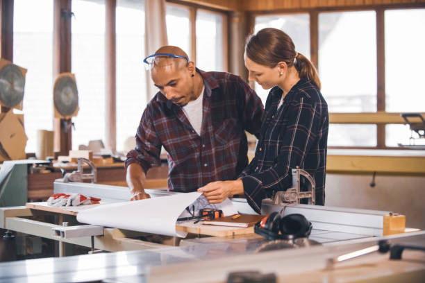 istock Couple of young carpenter working together 1476135490