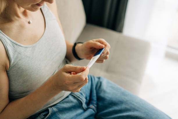 istock Unrecognizable woman checking pregnancy test, waiting for test result. 1476136504