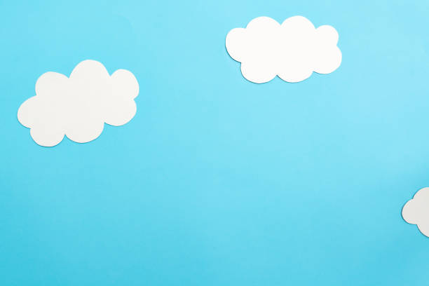 istock Paper clouds on blue background, flat lay, top view 1476137452