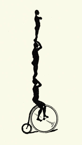 istock Silhouette of Victorian acrobats standing on each other's shoulders riding penny farthing cycle, 1890s, 19th Century 1476138926