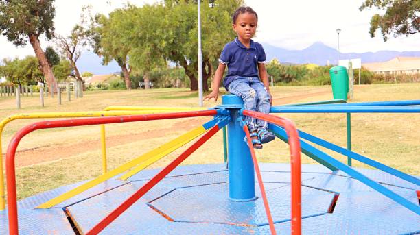 istock Young black African boy playing in a park 1476141412