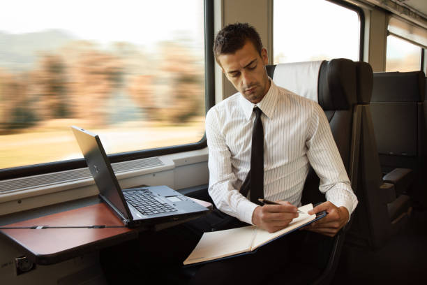 istock young businessman is traveling with railroad and working with computer 1476141655