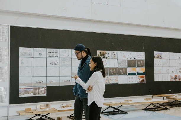 istock Asian architects partner, consult and discuss about exhibition of architecture student's thesis work for sustainable design subject 1476147442