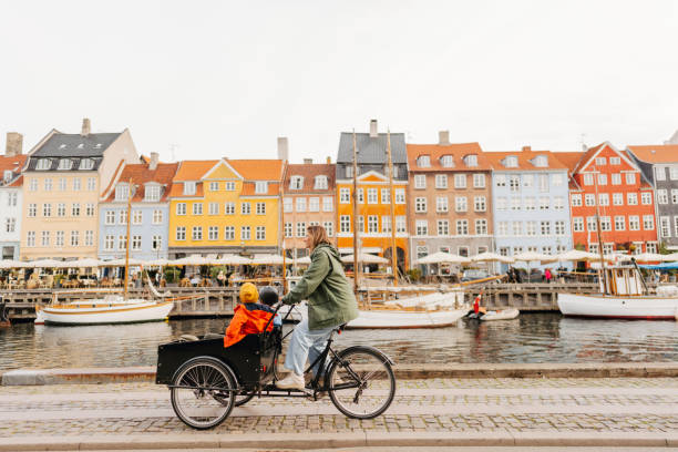 Cargo bike ride with mom Photo of two boys riding in a cargo bike with their mother in downtown of Copenhagen danish culture stock pictures, royalty-free photos & images