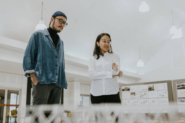 istock Asian architects discuss about the exiting model, show the space design is really great 1476147675