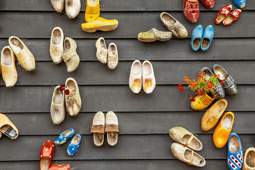 Traditional dutch wooden shoes hanging on a wall as decoration. Horizontally.