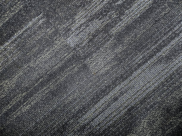 stock photo of a gray-colored, shaded diagonal stripe nylon cut pile textured carpet background. Picture captured at IT company office, Hyderabad, telangana, India. stock photo
