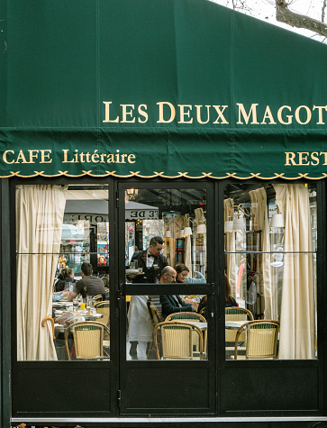 Paris,France,March 7th 2023: Tourists enjoying lunch at Les Deux Magots Cafe at Saint-Germain area in Paris.Saint-Germain area is famous to tourists for its chic and abundance of cafes, restaurants and galleries.