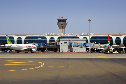 Dakar, Senegal: Blaise Diagne International Airport - Dakar international airport (AIBD, IATA DSS) - The main international airport of the Senegalese capital since 2017, when it replaced Dakar-Léopold Sédar Senghor Airport because it was no longer able to cope with rising passenger numbers and freight rates. Apron with two Airbus A319 on the passenger boarding bridges, Air Senegal on the left and Air Côte d'Ivoire on the right. Air traffic control tower in the background.