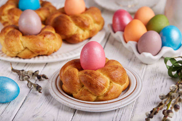 istock Traditional Easter bun bread in a shape of wreath made from yeast dough decorated with colored egg 1476165981