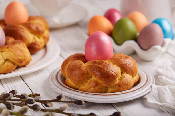 istock Traditional Easter bun bread in a shape of wreath made from yeast dough decorated with colored egg 1476165982