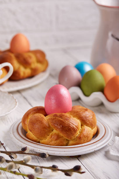 istock Traditional Easter bun bread in a shape of wreath made from yeast dough decorated with colored egg 1476165983