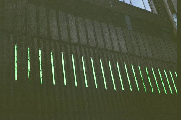 istock Green neon lights on building, dark, angled 1476167814