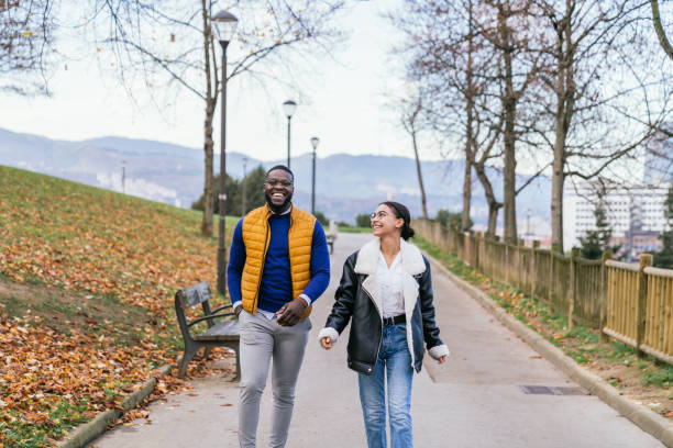 istock oyful Multicultural Couple Strolling Through a Colorful Autumn Park 1476172026