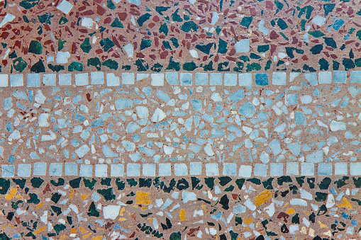 Detail of an ancient Italian mosaic and grit flooring called Venetian floor made with small grains of colored stone