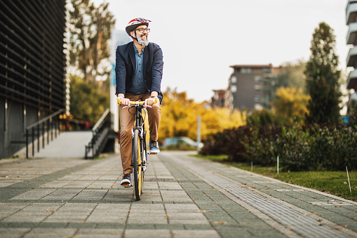 istock A Businessman Traveling To Work With A Bike 1476174747