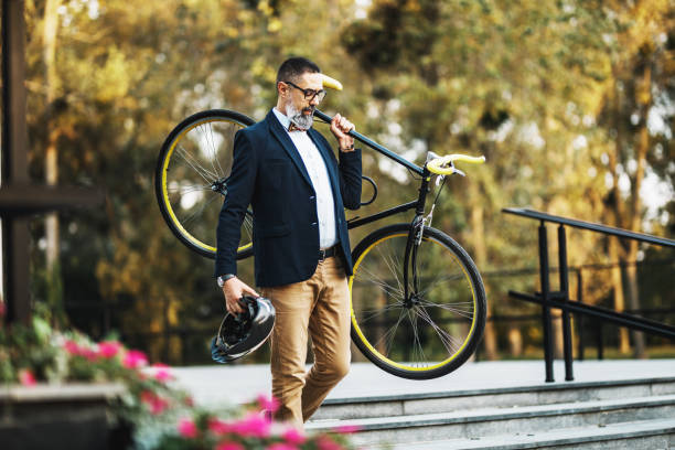 istock A Businessman Carrying A Bicycle Over The Stairs While Traveling To Work 1476174914
