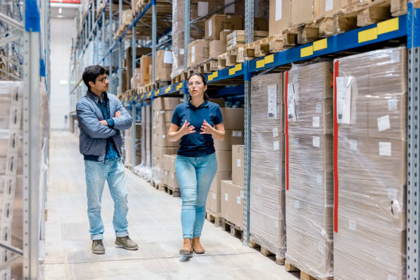 istock Supervisor walking and talking with male worker in warehouse 1476174927