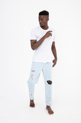 Black man of African descent wearing a white t-shirt. Expressionless. isolated on white.