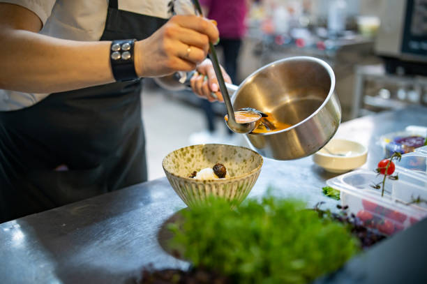 istock woman chef cooking Tom Yam soup on restaurant kitchen 1476177418