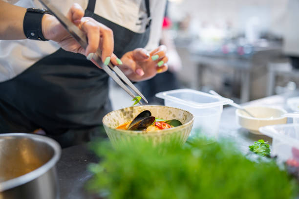 istock woman chef cooking Tom Yam soup on restaurant kitchen 1476177422