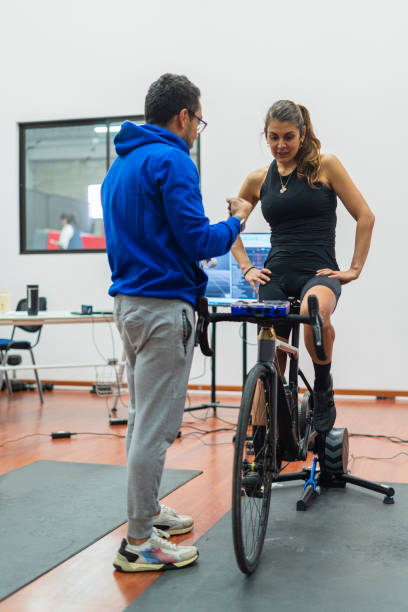 istock Latino man is inside his physical rehabilitation office for cyclists who does them through the technology of his laptop and technological devices 1476180553