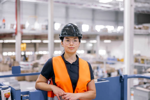 istock Portrait of confident female worker working in large warehouse 1476180623