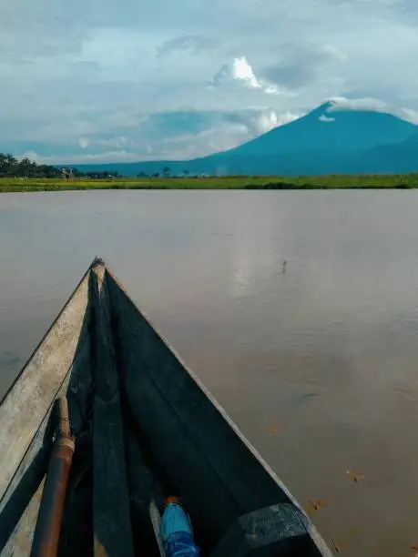 Portrait of Rawa Pening (Rawapening) lake from traditional wooden boat with Mount Merbabu background in Central Java, Indonesia