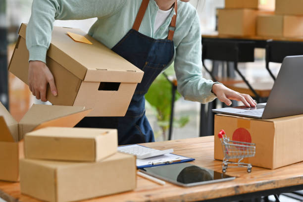 istock Startup small business SME, Entrepreneur owner using laptop checking online purchase shopping order to preparing sending product box. 1476182678