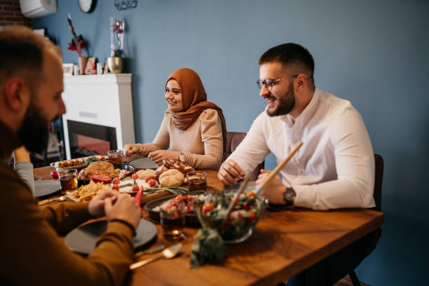istock Young people sitting together while enjoying a meal in celebration of Ramadan 1476194468