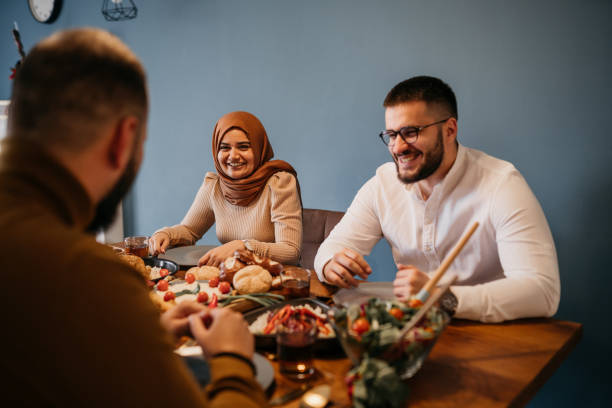 istock Young people sitting together while enjoying a meal in celebration of Ramadan 1476194471
