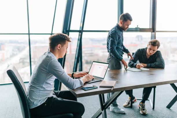 istock A male trainer teaching a group of trainees how to use a new software on their 1476194672