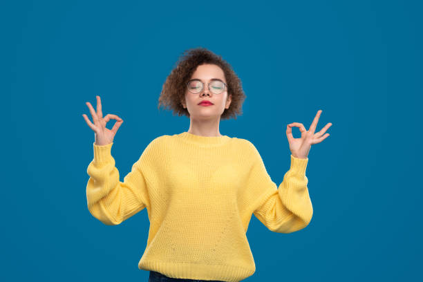 istock Tranquil young woman meditating with mudra gesture 1476194926