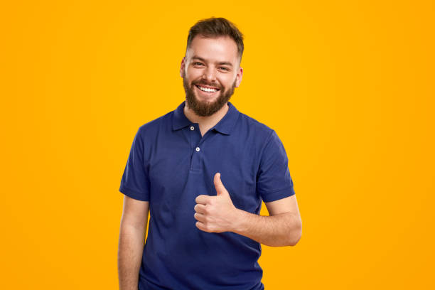 istock Content man showing thumb up on yellow background 1476194981