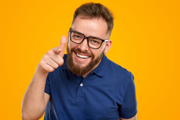 istock Positive bearded man in eyeglasses pointing at camera 1476195014