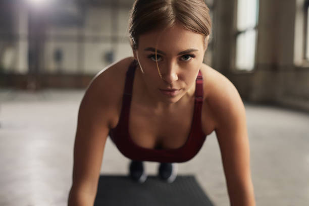 istock Confident sportswoman doing plank exercise 1476195107