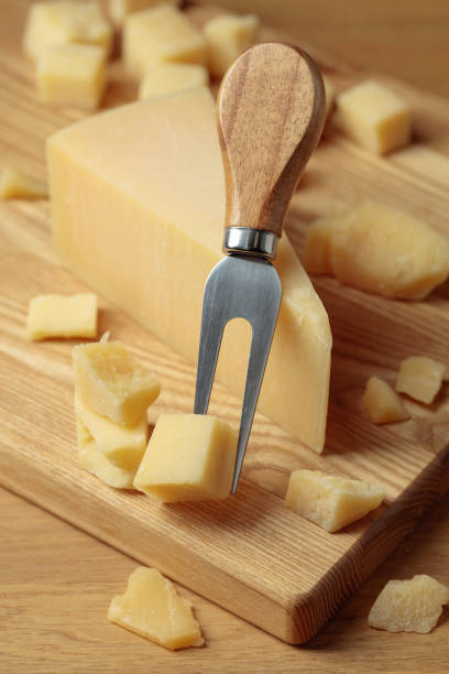 istock Parmesan cheese and fork on a cutting board. 1476198866